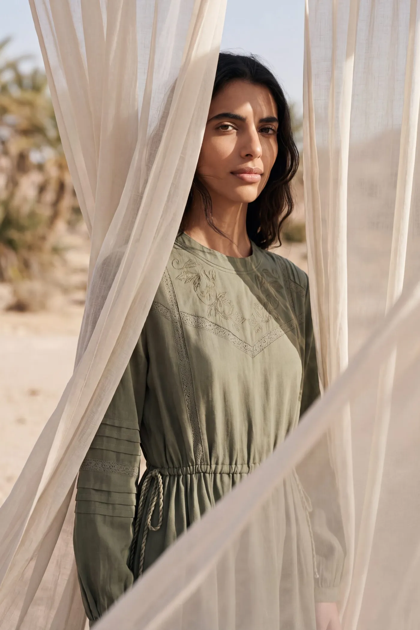 KINSHIP – olive dress between linen curtains