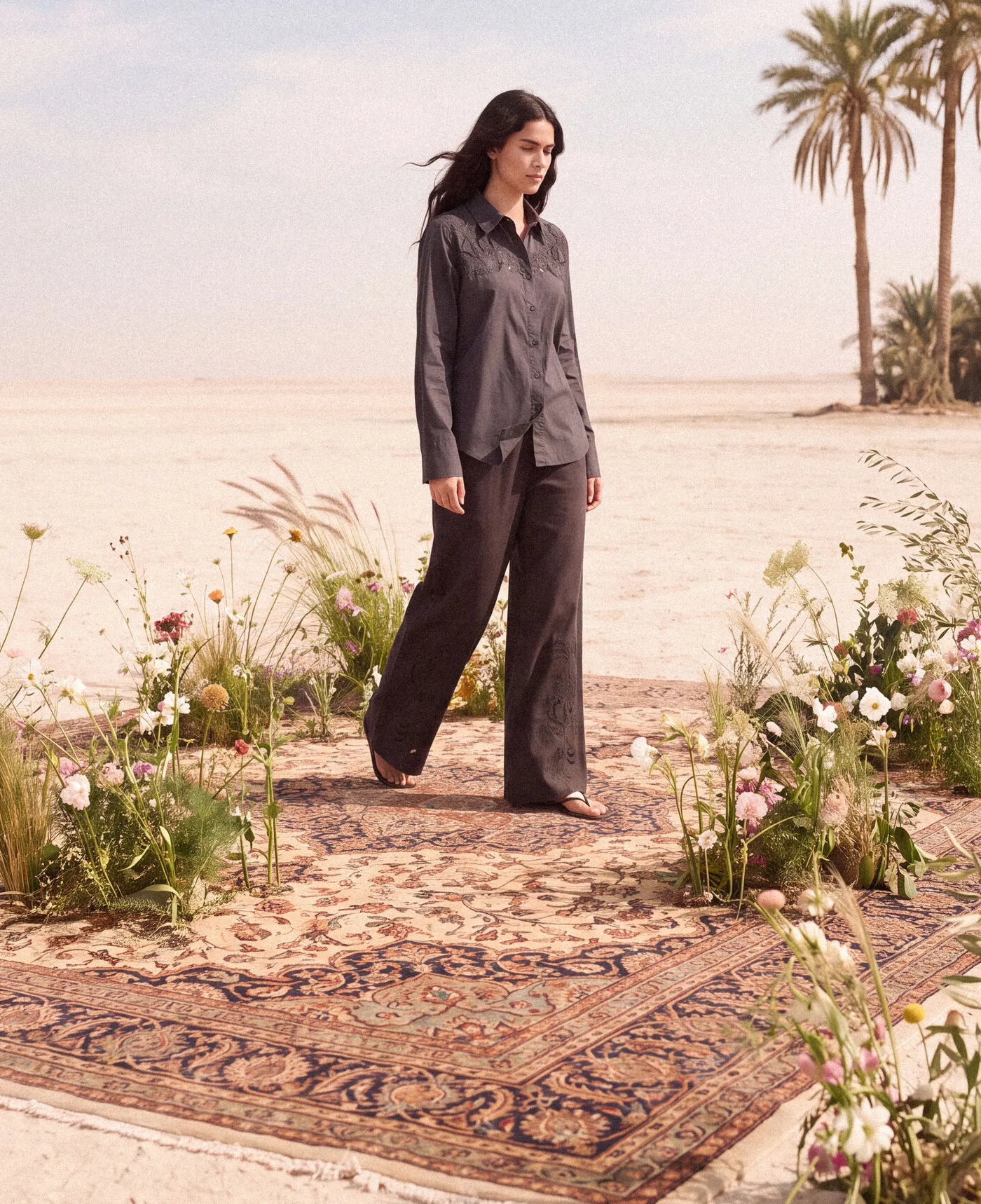 KINSHIP – grey shirt and trouser set on a woven rug