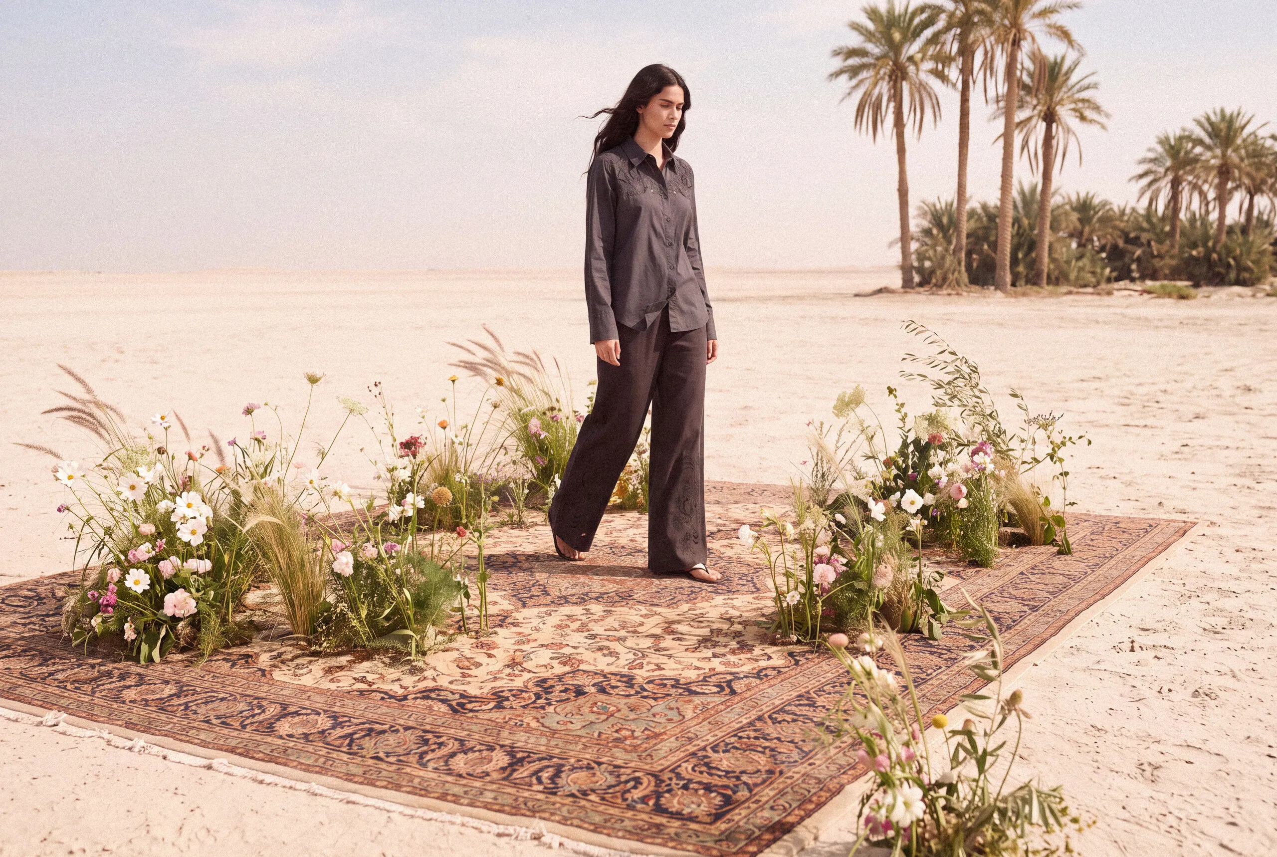 KINSHIP – grey shirt and trouser set on a woven rug