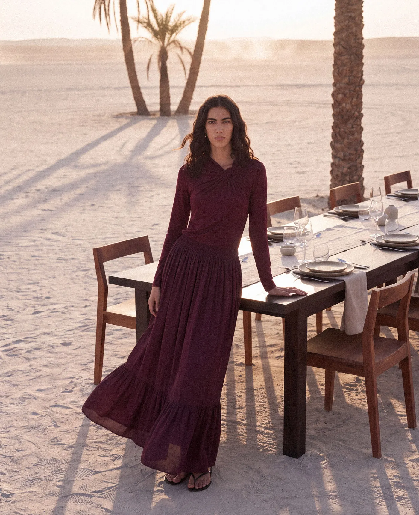KINSHIP – burgundy dress beside a dining table